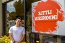 student standing outside Little Indonesia storefront in Somersworth